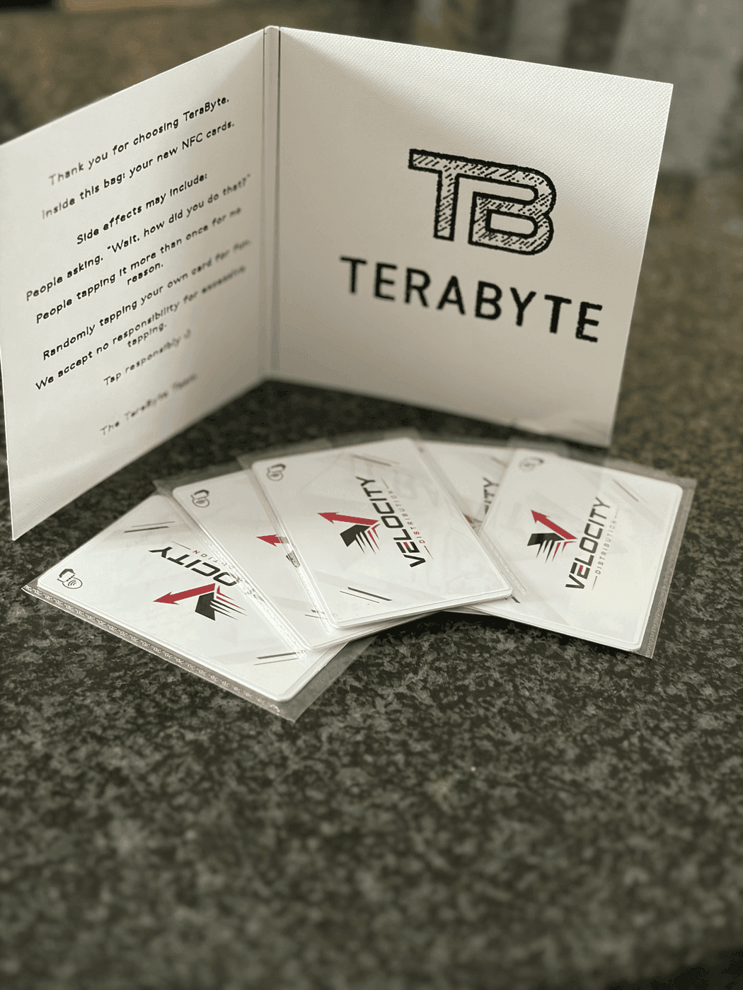 Velocity Distribution branded NFC cards in a welcome kit box